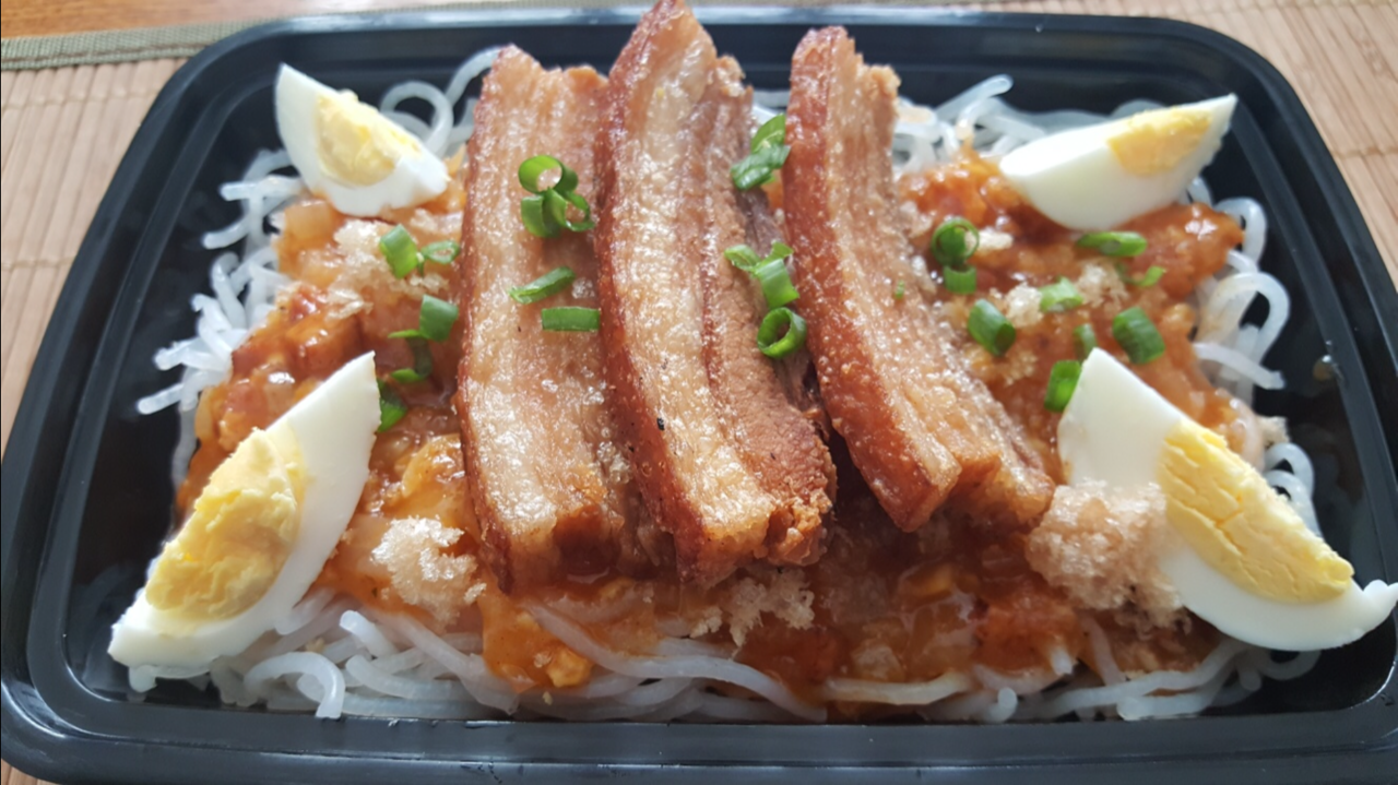 Palabok noodles topped with crispy fried pork belly from IslandMix’s food truck